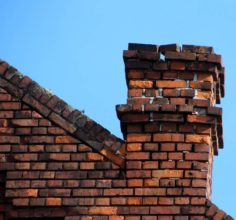 Damaged chimney on an Allenton home showing cracks and missing mortar